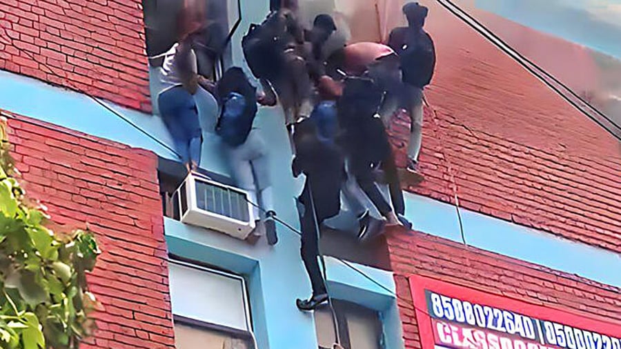 Students being rescued after a fire broke out at a coaching institute, at Mukherjee Nagar area in New Delhi, Thursday, June 15, 2023. Credit: PTI Photo