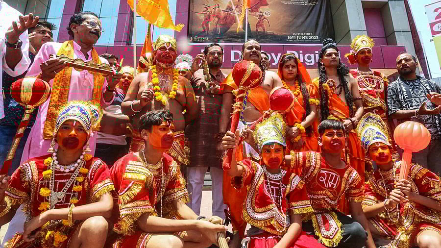 BJP workers with artists dressed as Lord Ram, Laxman, Hanuman and Goddess Sita arrive to watch the movie 'Adipurush' on the first day of its release, in Bhopal. Credit: PTI Photo