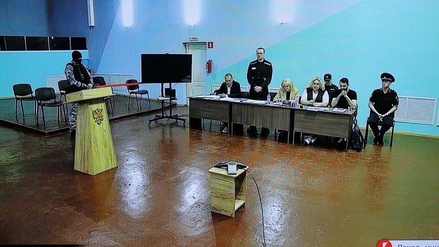 Alexei Navalny is seen on a screen via a video link during an external hearing in a new criminal case against him on numerous charges. Credit: Reuters Photo