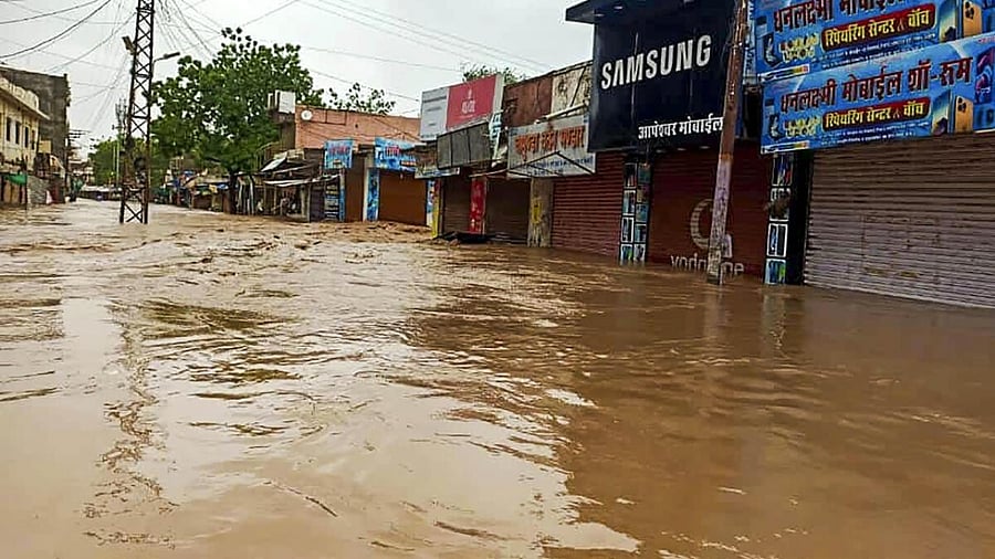 View of a flooded street due to heavy rainfall caused by cyclone Biparjoy, in Sanchore, Sunday, June 18, 2023. Credit: PTI Photo