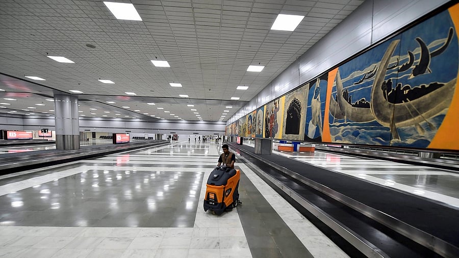 A worker cleans the floor of the revamped Terminal 2 of the Indira Gandhi International Airport in New Delhi. Credit: PTI File Photo