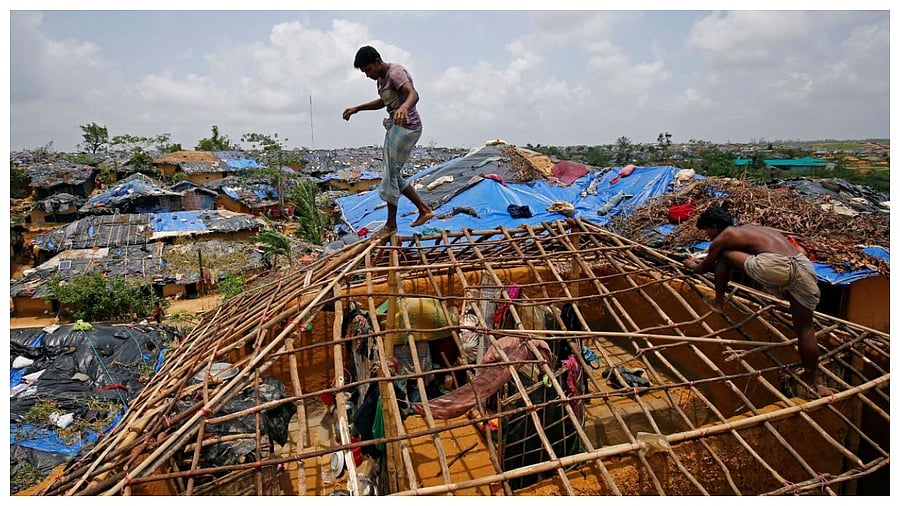 Rohingya refugees rebuild their makeshift house, which was destroyed by Cyclone Mora, at the Kutupalang Makeshift Refugee Camp in Cox's Bazar, Bangladesh June 1, 2017. Credit Reuters File Photo