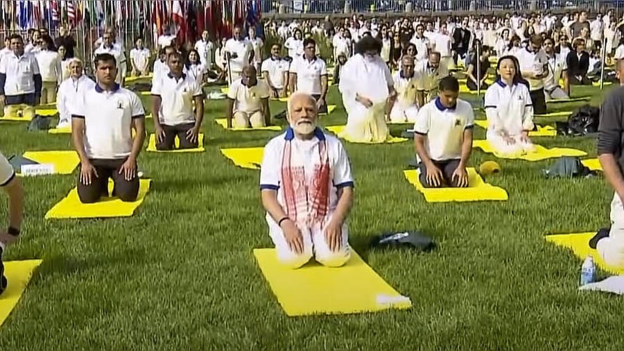 Prime Minister Narendra Modi performs yoga with others during the 9th International Day of Yoga celebrations at the UN headquarters, in New York, Wednesday, June 21, 2023. Credit: PTI Photo