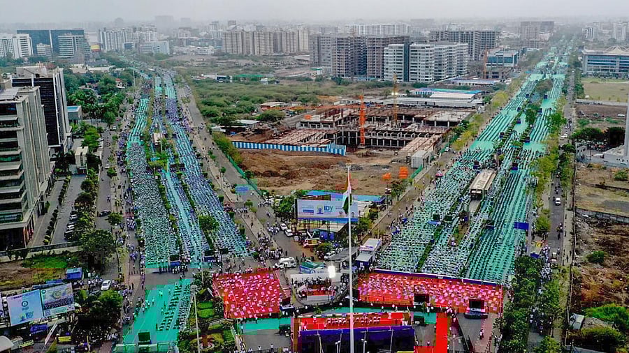 People perform yoga at a programme organised on the International Day of Yoga, in Surat, Wednesday, June 21, 2023. The event has set a new Guinness World Record for the 'largest gathering of people for a yoga session at one place'. Credit: PTI Photo