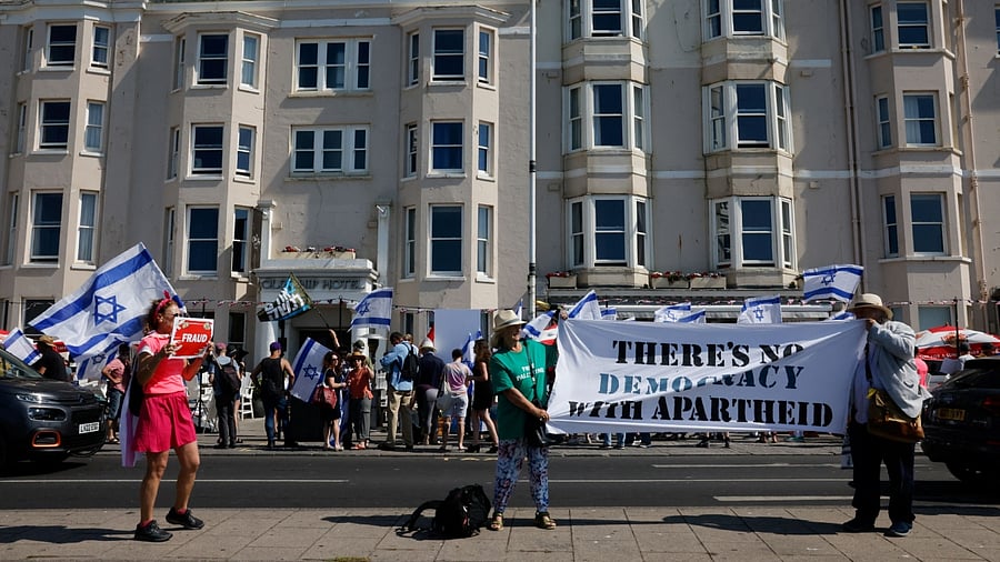 Demonstrators protest outside The Old Ship Hotel on the day Arnon Milchan, a Hollywood producer and Israeli citizen is expected to provide testimony, in Brighton, Britain June 25, 2023. Credit: Reuters Photo
