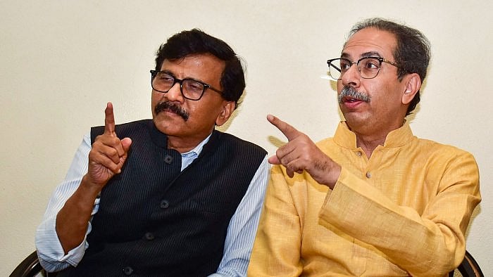 Shiv Sena (UBT) chief Uddhav Thackeray with party leader Sanjay Raut during a press conference. Credit: PTI Photo