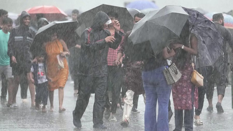 Pedestrians at Marine Drive amid rain, in Mumbai, Thursday, June 29, 2023. Credit: PTI Photo