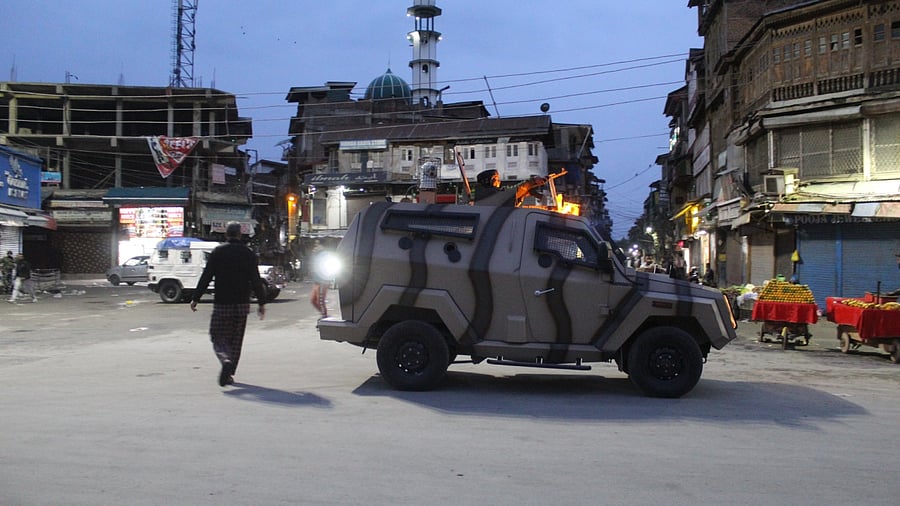 Security forces take positions after the evening prayers during Ramzan. Credit: DH Photo/ Anand Singh