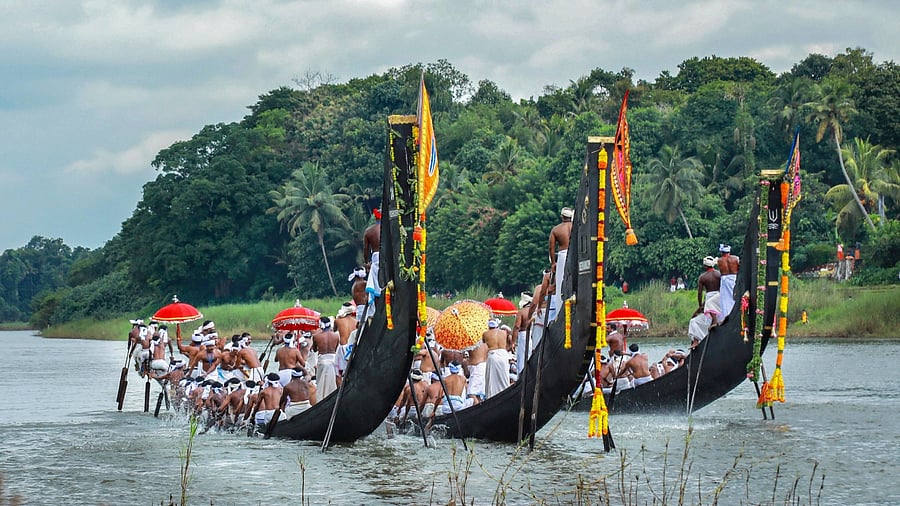 Boatmen with their snake boats participate in Aranmula boat race, at Aranmula in Pathanamthitta district of Kerala, August 25, 2021. Credit: PTI Photo 