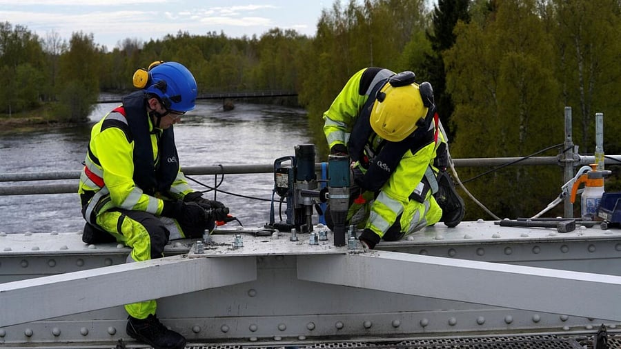Construction workers are seen on a bridge over Raumo river in Tornio, Finland May 31, 2023. Credit: Reuters Photo