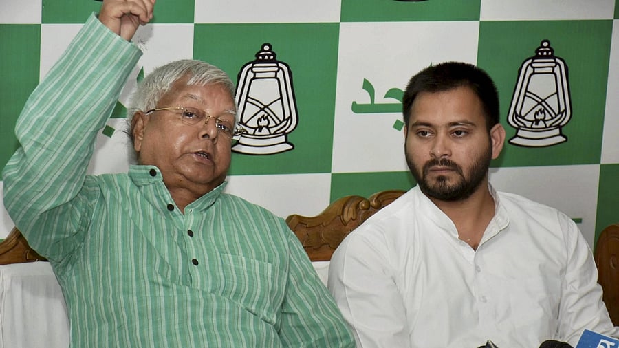 RJD chief Lalu Prasad Yadav (L) and Bihar Deputy Chief Minister Tejashwi Yadav (R). Credit: PTI File Photo