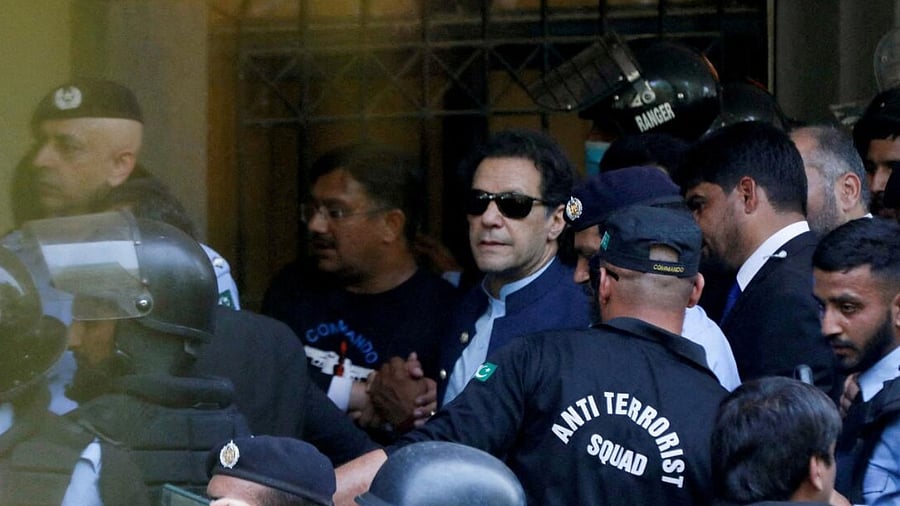 Security officers escort Pakistan's former Prime Minister Imran Khan as he appeared in Islamabad High Court. Credit: Reuters File Photo