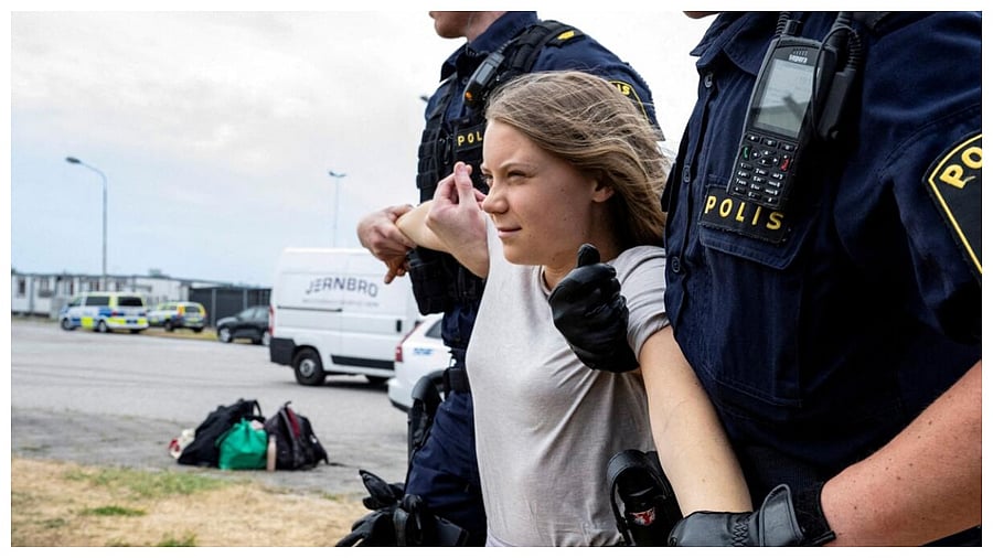 Police remove Greta Thunberg as they move climate activists who are blocking the entrance to Oljehamnen in Malmo. Credit: Reuters File Photo