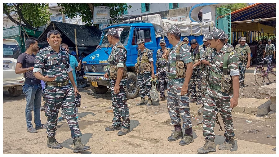 Security personnel stand guard outside a strong room where ballot boxes are kept a day after the West Bengal's panchayat polls, at Gazole in Malda district, Sunday, July 9, 2023. Credit: PTI Photo