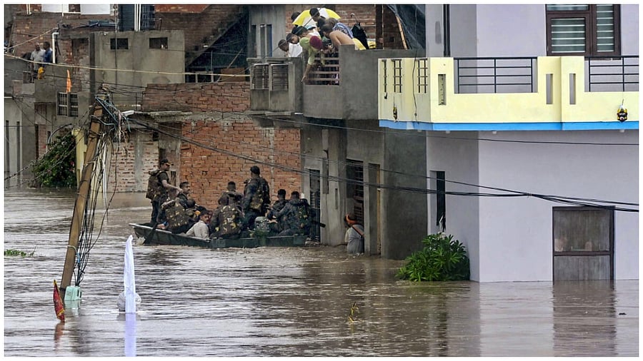Patiala: Army personnel evacuate locals from a flooded area after the overflow of Badi Nadi river following heavy monsoon rains, at Gopal Colony in Patiala district, Monday, July 10, 2023. Credit: PTI Photo