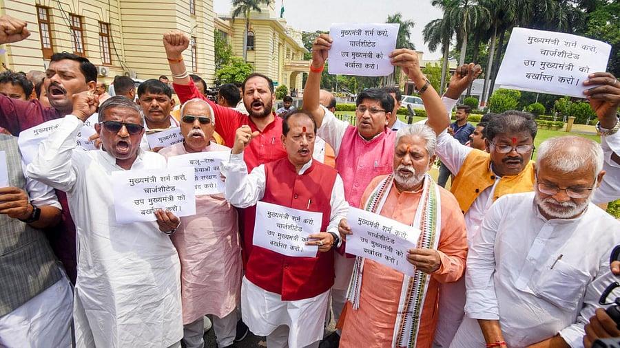  Leader of Opposition in Bihar Assembly Vijay Kumar Sinha with party legislators stages a protest demanding the dismissal of Bihar Deputy CM Tejashwi Yadav over his alleged involvement in the land for jobs scam case during Monsoon Session of the Assembly, in Patna. Credit: PTI Photo