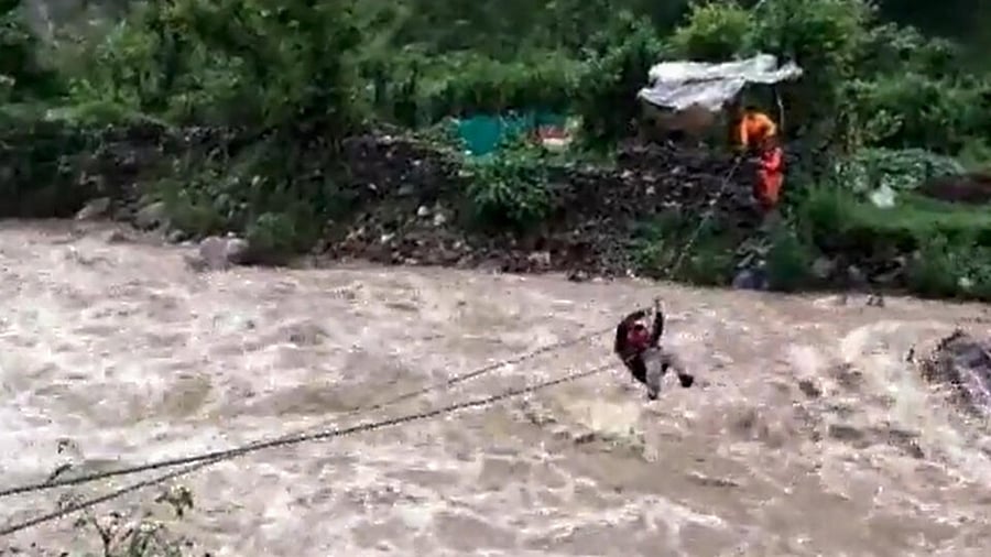 National Disaster Response Force (NDRF) personnel rescue a trapped victim due to heavy rain and high-water level of the Kalsa river at Alchona village, in Nainital district, Thursday, July 6, 2023. Credit: PTI Photo