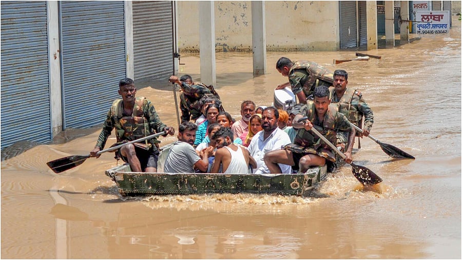 Patiala: Indian Army personnel rescue people stuck in the flooded Sanauri Adda area after an increase in the water level of Badi Nadi river following heavy monsoon rain, in Patiala, Tuesday, July 11, 2023. Credit: PTI Photo