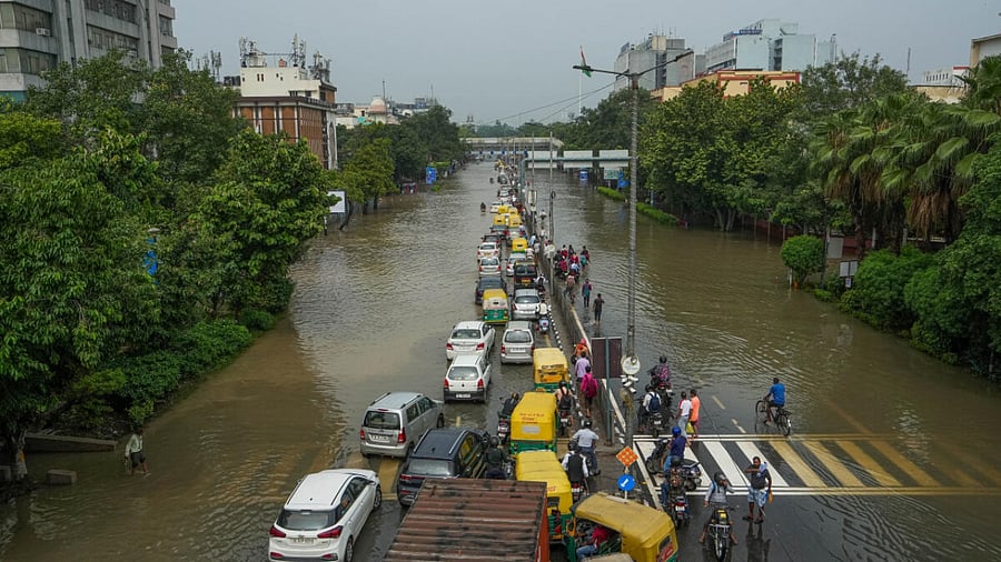 Vehicles make their way through a waterlogged road at ITO as the Yamuna river floods nearby areas, in New Delhi. Credit: PTI Photo