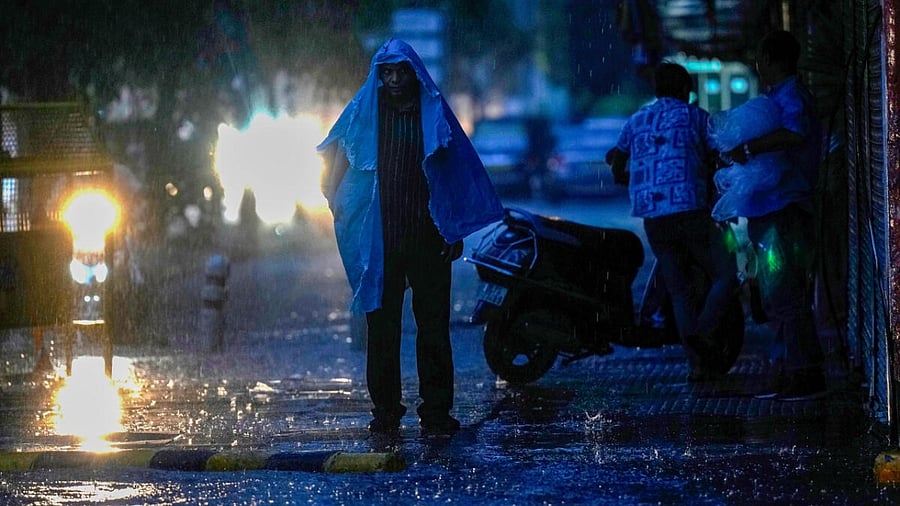 A pedestrian on a road amid monsoon rain, in New Delhi, Saturday, July 15, 2023. Credit: PTI Photo