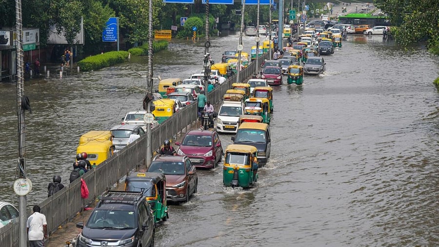 Commuters move through the floodwaters of the swollen Yamuna river, at ITO, in New Delhi, Sunday, July 16, 2023. Credit: PTI Photo