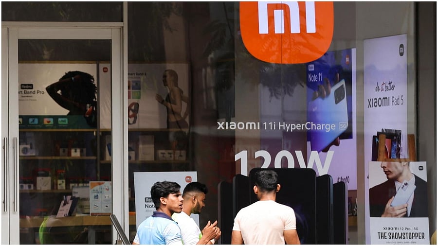 People walk past Xiaomi consumer electronics store in Mumbai. Credit: Reuters Photo