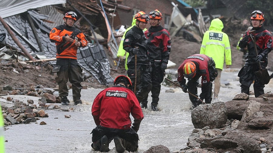 People take part in a search and rescue operation at a landslide caused by torrential rain in Yecheon, South Korea. Credit: Reuters Photo