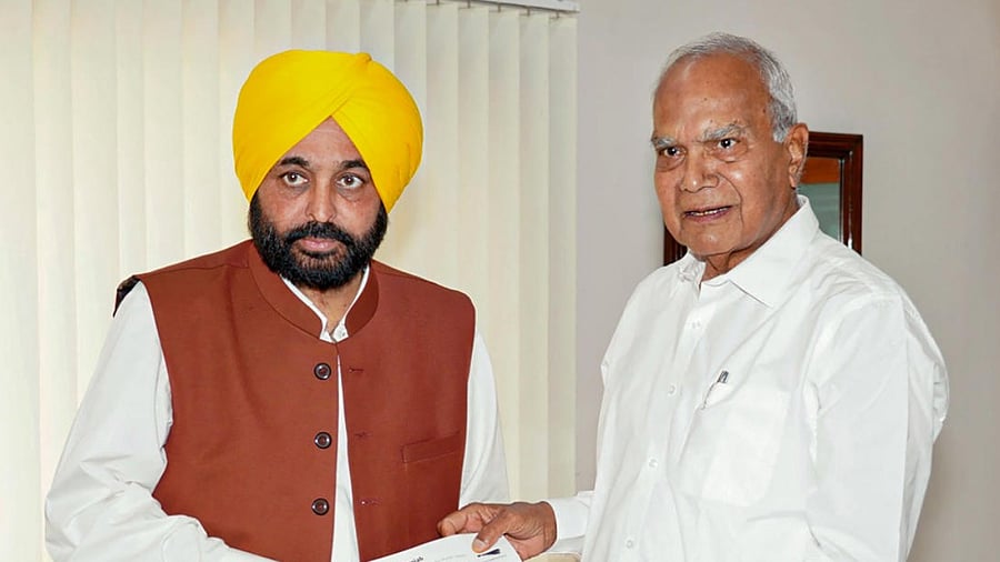 Punjab CM Bhagwant Mann with state Governor Banwarilal Purohit. Credit: PTI Photo