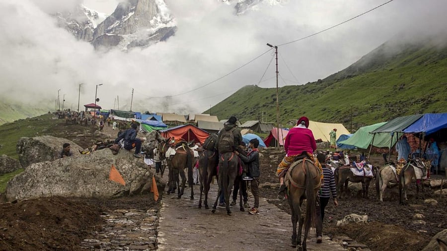 Devotees make their way to Kedarnath Temple, in Kedarnath on Thursday, July 12, 2018. Credit: PTI Photo