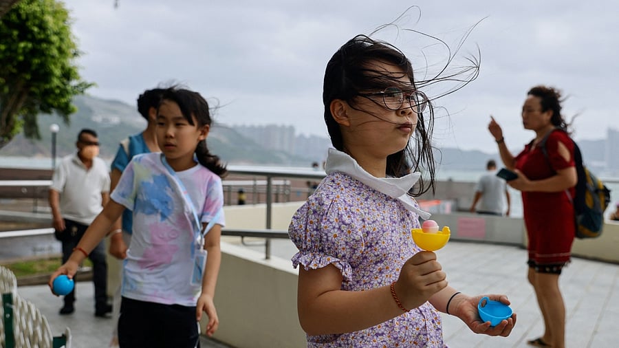 People walk at the seaside as Typhoon Talim approaches, in Hong Kong, China. Credit: Reuters Photo