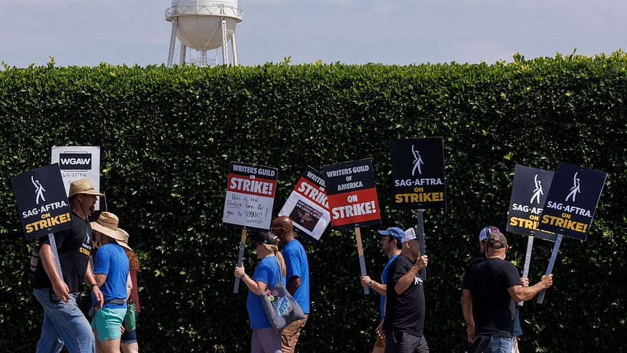 <div class="paragraphs"><p>SAG-AFTRA actors and Writers Guild of America (WGA) writers walk the picket line in front of Paramount Studios in Los Angeles. </p></div>