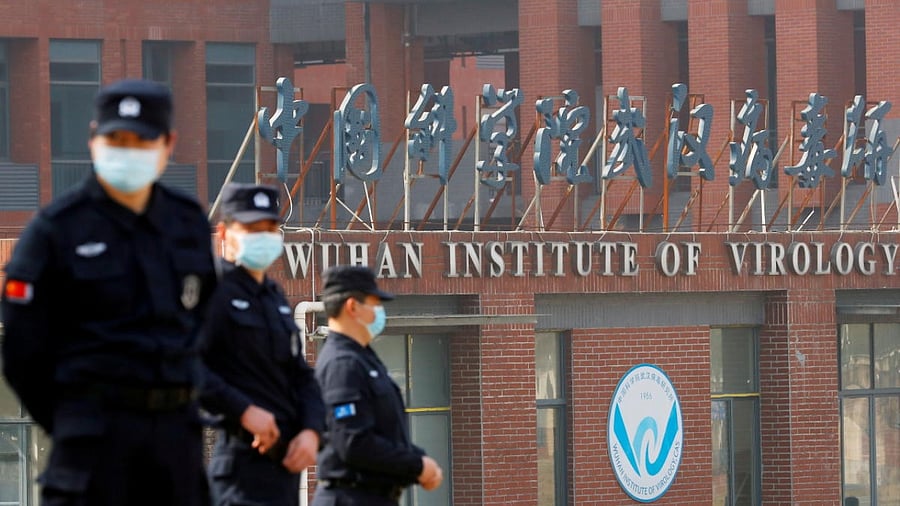 <div class="paragraphs"><p>Security personnel keep watch outside the Wuhan Institute of Virology during the visit by the World Health Organization team. </p></div>