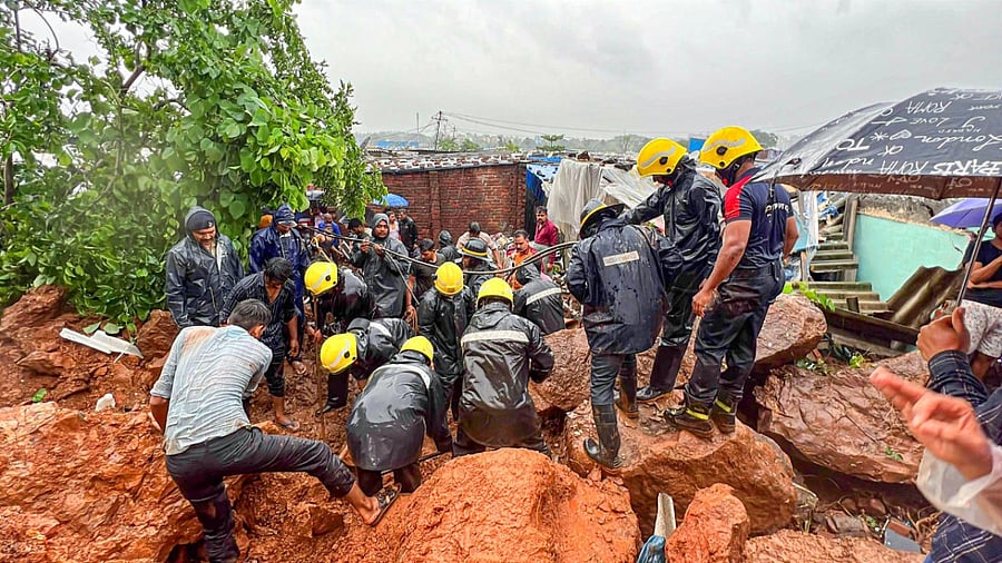 NDRF and fire services personnel carry out rescue and relief work following a landslide triggered by heavy monsoon rains, in Vasai near Mumbai, on Wednesday. Credit: PTI Photo