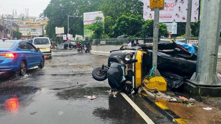 Damaged auto-rickshaw after it collided with an electric lamp post amid heavy monsoon rains, in Junagadh. Credit: PTI Photo