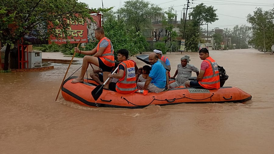 State Disaster Response Force (SDRF) personnel evacuate people from the flooded industrial area of Ambala Cantt. Credit: PTI Photo