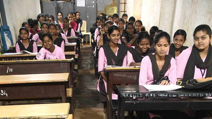 Students are forced to sit in leaking classrooms to attend classes at the Government First Grade Women's College near R N Shetty Stadium in Dharwad. Credit: DH Photo