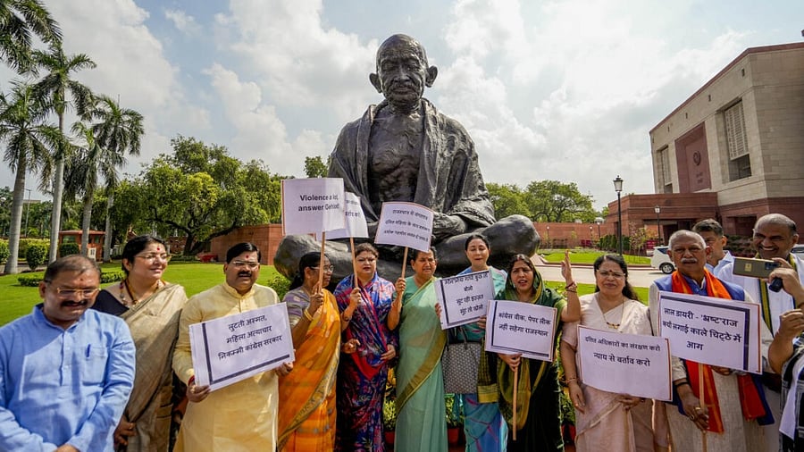 BJP Rajasthan MPs along with senior leaders stage a protest in front of the Gandhi statue against Rajasthan Chief Minister Ashok Gehlot, at Parliament House complex in New Delhi. Credit: PTI Photo