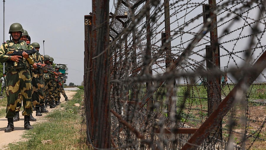 Border Security Force (BSF) personnel patrol near the international border, in Samba district, Saturday, April 29, 2023. Security has been put on high alert across Jammu and Kashmir ahead of a G20 meeting on tourism in Srinagar next month. Credit: PTI Photo