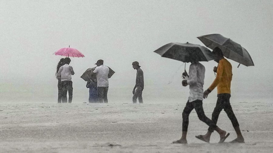 People during monsoon rains, in Mumbai, Wednesday, July 26, 2023. Credit: PTI Photo