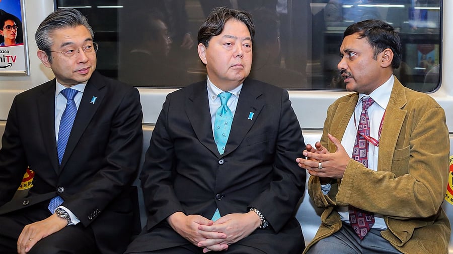 Japanese Foreign Affairs Minister Yoshimasa Hayashi (2L) with Ambassador of Japan to India Hiroshi Suzuki (L) and Director (Operations & Services), DMRC, Amit Kumar Jain (2R) travels in the Delhi Metro. Credit: PTI Photo