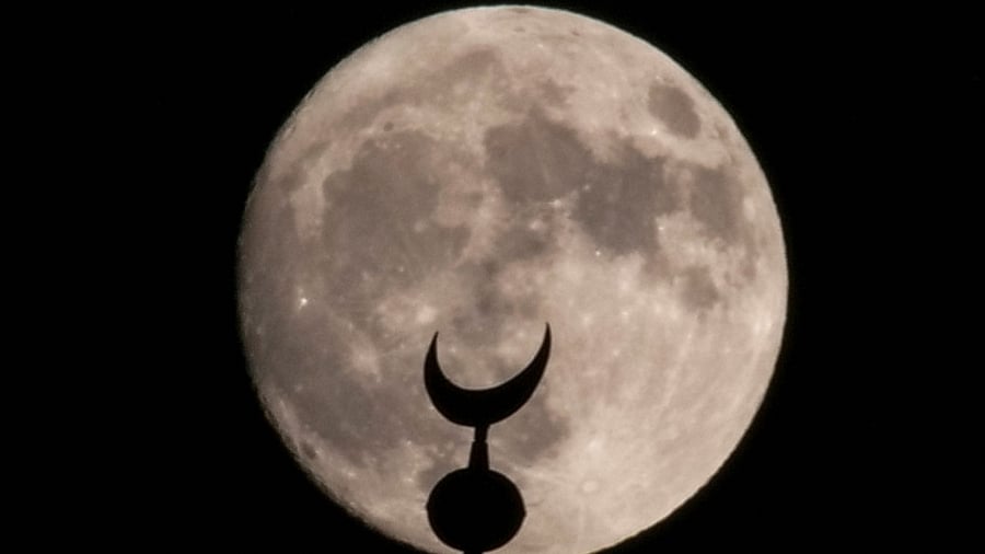 A supermoon, also known as a Sturgeon moon, rises over Tower of David in Jerusalem's Old City, July 31, 2023. Credit: Reuters Photo