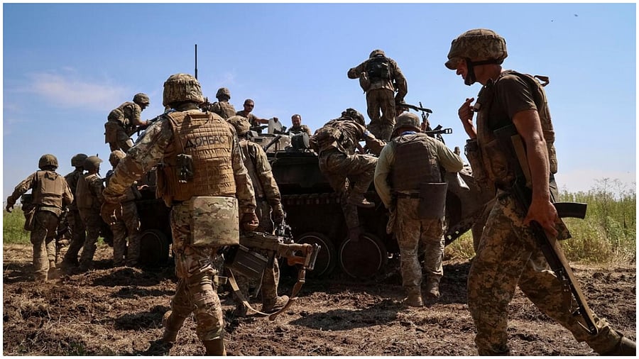 Ukrainian service members climb a BMP-2 infantry fighting vehicle, amid Russia's attack on Ukraine, in Zaporizhzhia region, Ukraine July 31, 2023. Credit: Reuters Photo