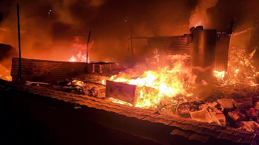 Flames rise from shops and other structures set ablaze by miscreants during fresh violence in Haryana. Credit: PTI Photo