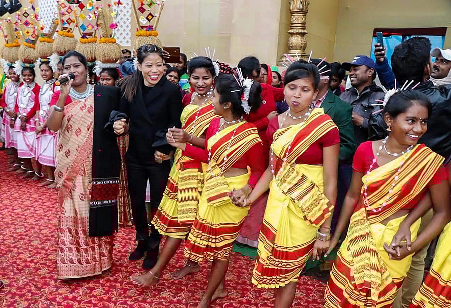 Ace boxer MC Mary Kom (in black) takes part in Gunj Mahotsav, a tribal festival, at Silli near Ranchi, Tuesday, December 18, 2018. (PTI Photo) 