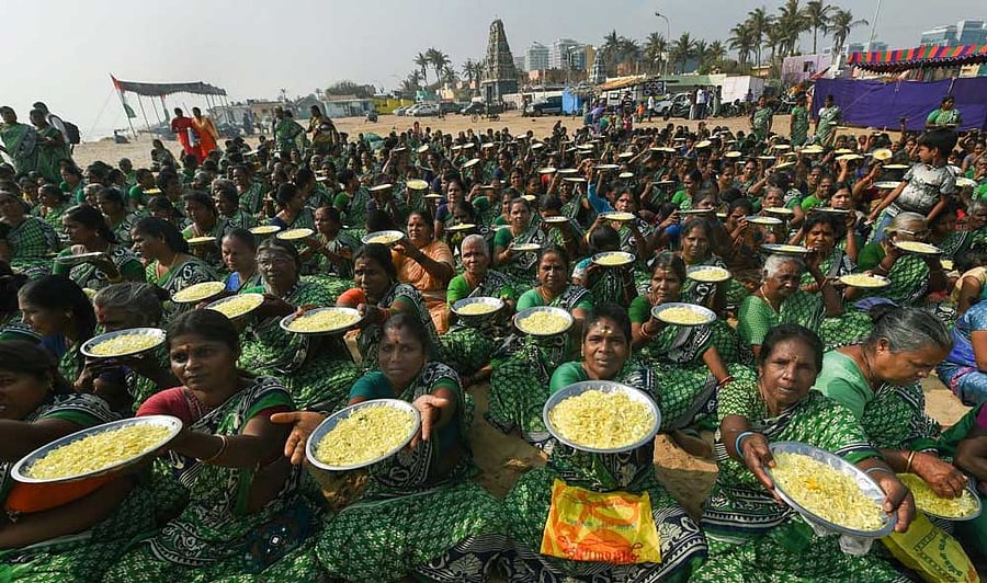 Women carry flower petals to pay tributes to the victims of tsunami 2004 on the 14th anniversary of the calamity, at Foreshore Estate beach (Pattinapakkam beach) in Chennai. PTI Photo