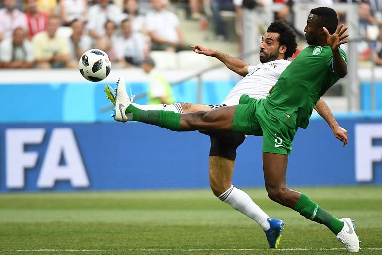 Egypt's forward Mohamed Salah (L) and Saudi Arabia's defender Osama Hawsawi fight for the ball during the Russia 2018 World Cup Group A football match between Saudi Arabia and Egypt at the Volgograd Arena in Volgograd on June 25, 2018.  Source: Philippe DESMAZES / AFP