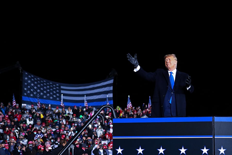 US President Donald Trump reacts to the crowd while walking to the podium during a campaign event at the Waukesha County Airport in Waukesha, Wisconsin. Credit: Reuters Photo