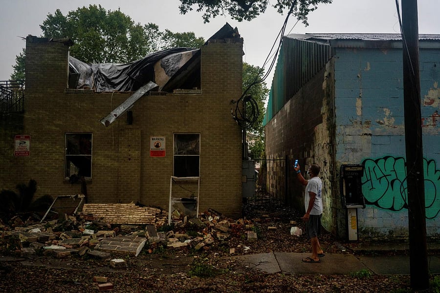 Joel Martinez, who until just recently lived in the lower apartment, makes a photo of Washington Garden's Apartments after it collapsed from the winds brought by Hurricane Zeta in New Orleans, Louisiana. Credit: Reuters Photo