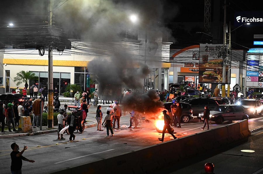 Supporters of former President Manuel Zelaya Rosales (2006-2009) protest near Toncontin International Airport, where he is being held in Tegucigalpa. Former Honduran President Manuel Zelaya Rosales was held at Toncontin International Airport on Friday in possession of 18,000 US dollars in cash. Credit: AFP Photo