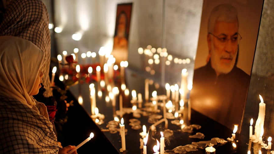 A girl holds a lit candle during the first anniversary of the killing of senior Iranian military commander General Qassem Soleimani and Iraqi militia commander Abu Mahdi al-Muhandis in a US attack, in Baghdad, Iraq. Credit: Reuters